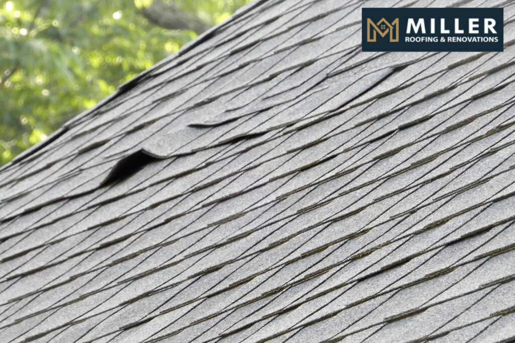 Close-up of shingle roof with visible damage and curling edges