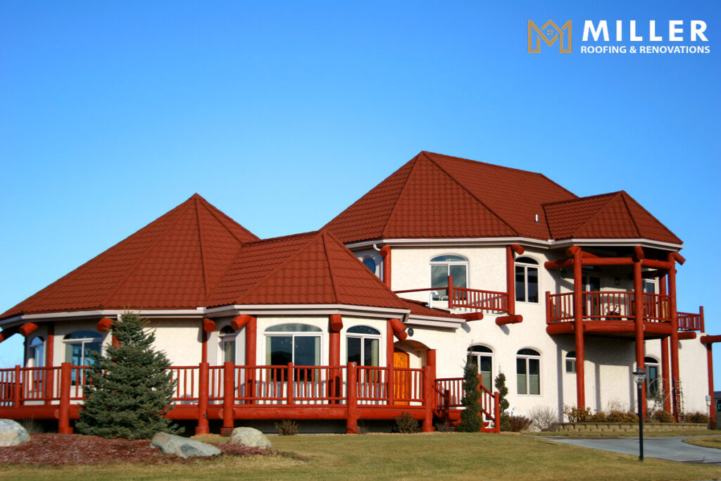 Modern house with red roof and balcony under clear blue sky