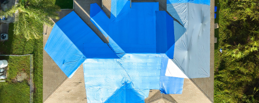 Aerial view of modern blue swimming pool with geometric design surrounded by deck